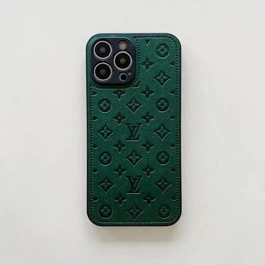 Green leather iPhone case with embossed monogram pattern on white background