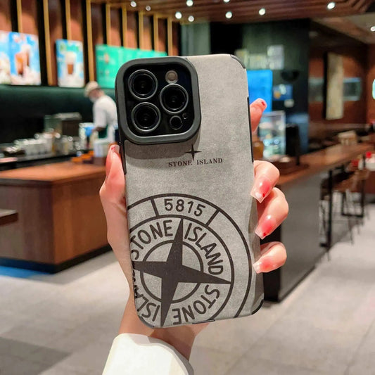 Stone Island iPhone case held in hand at modern coffee shop