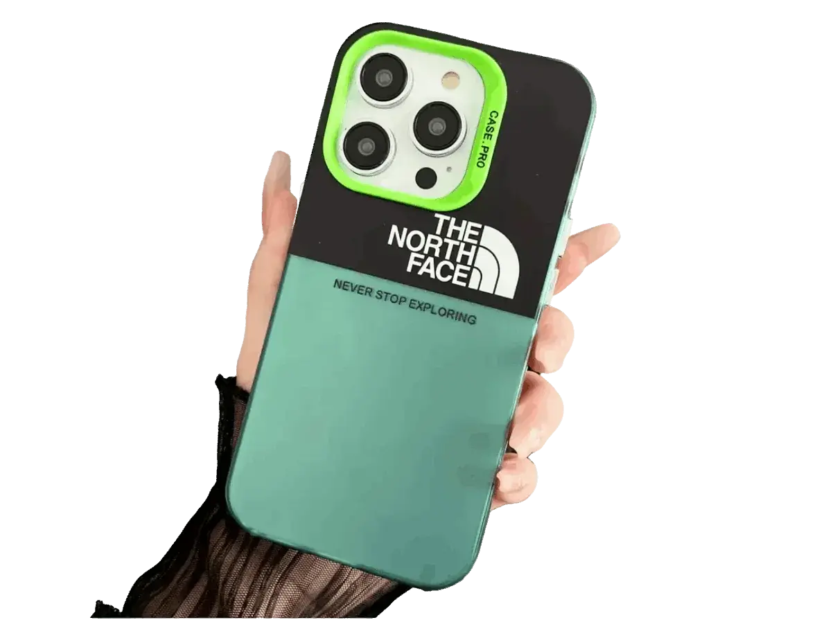 Hand holding turquoise and black North Face iPhone case with camera cutout