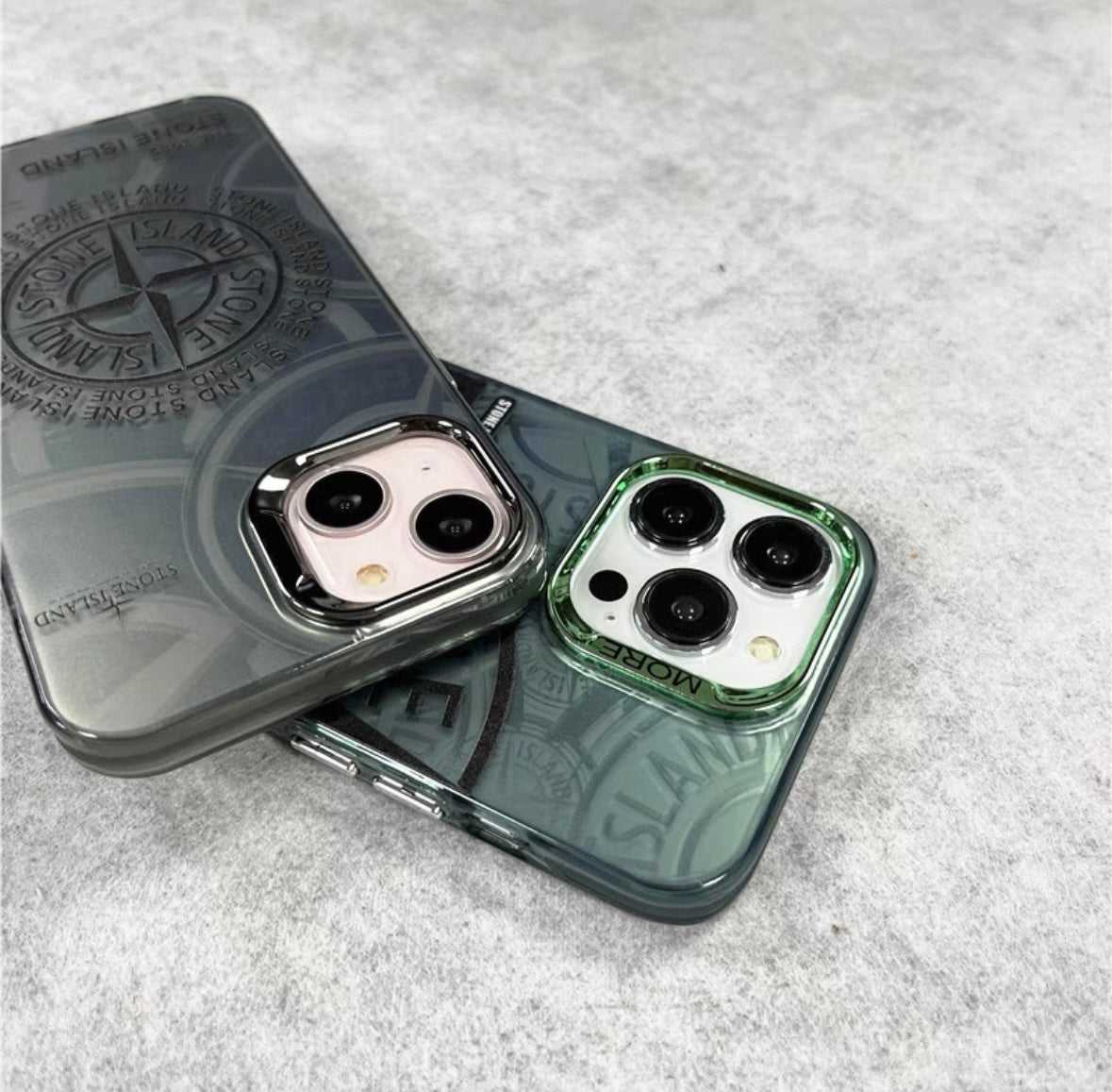 Two smartphones with Stone Island compass logo cases on a light gray surface