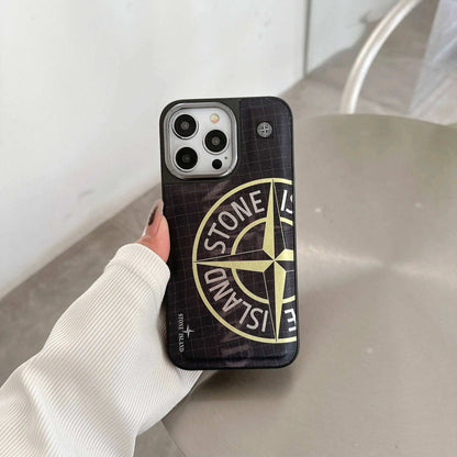 Person holding iPhone with black Stone Island logo case on modern table
